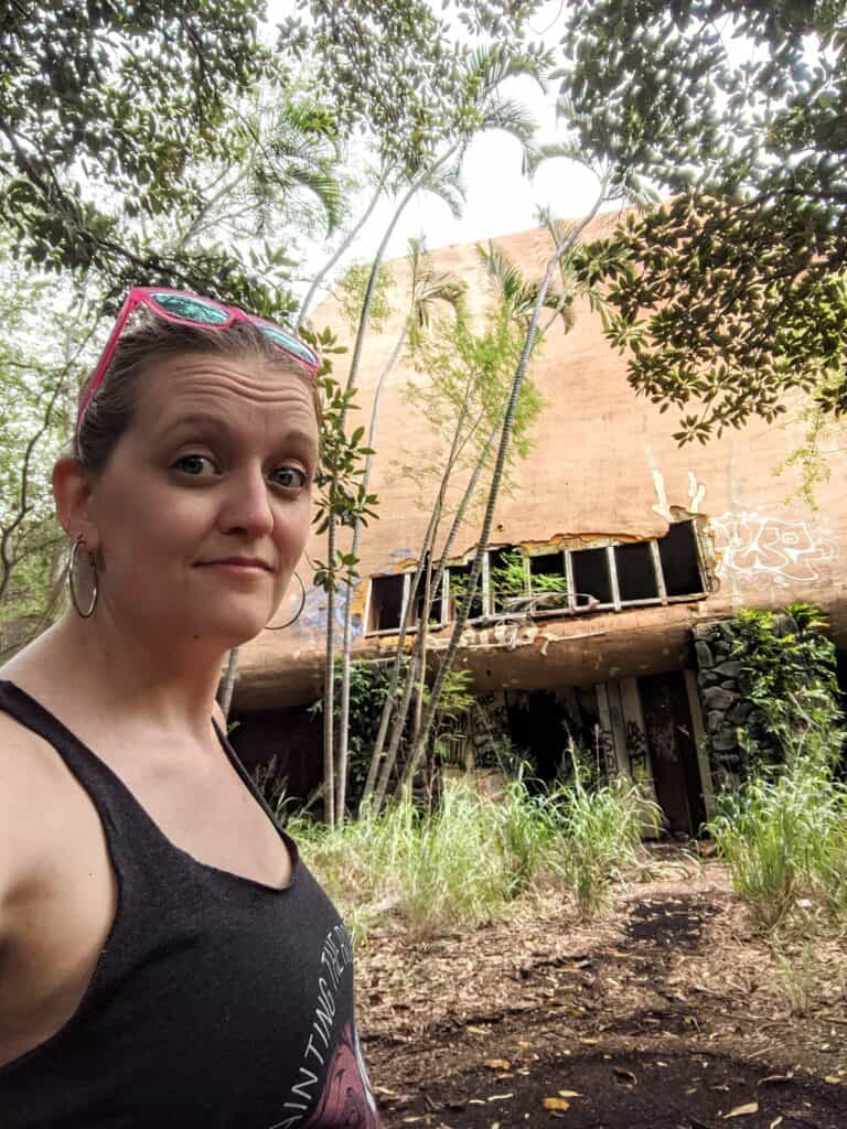 selfie with a ruined buliding getting overrun by the forest