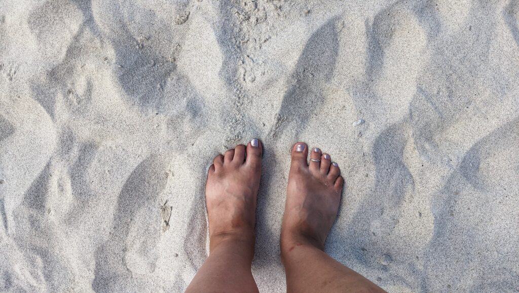 barefoot on the white sands of kua bay beach