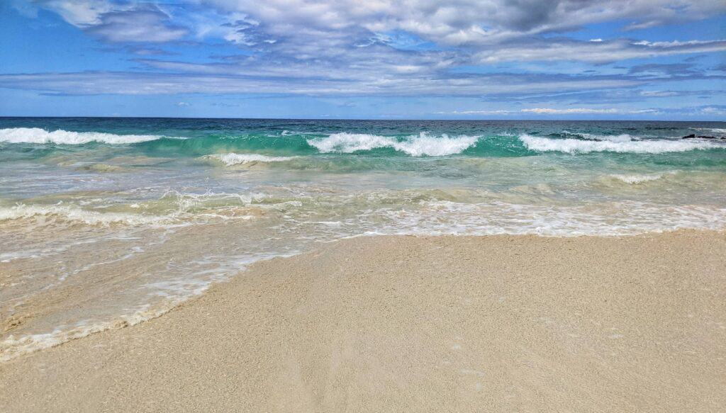azure waves crashing onto makalawena beach
