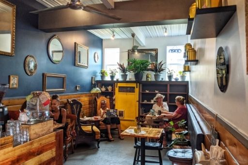 dining room with eclectic vintage furniture in tealicious kona