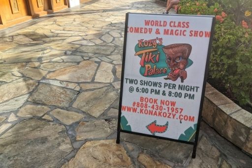 Advertisement for Kozak's Tiki Palace showing times for a comedy and magic show, an example of evening entertainment available on the Big Island