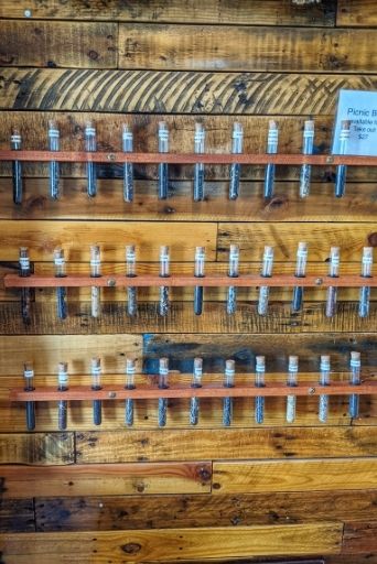 wall of loose leaf teas in test tubes at tealicious kona