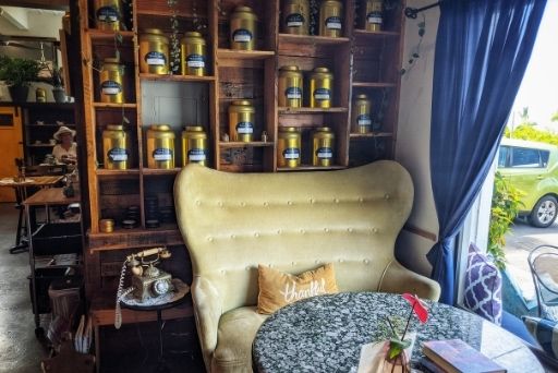 insdie tealicious cafe with giant couch and tins of tea behind it