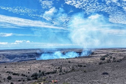 smoking kilauea volcano with a blue sky