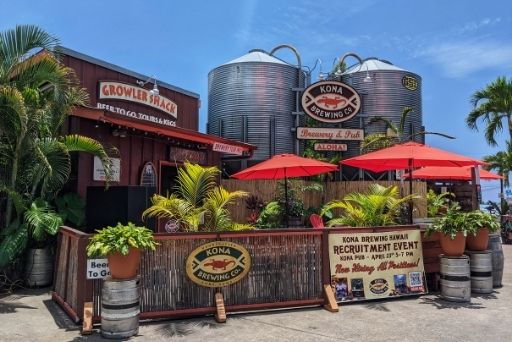 entrance to kona brewing company with beer vats towering