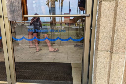 Entrance to Pacific Tsunami Museum with tsunami marker on how high the water rose