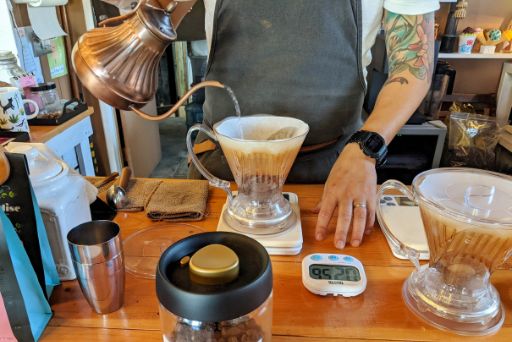 hands making pourover coffee at Koana