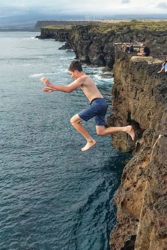 kid jumping off of cliffs at south point