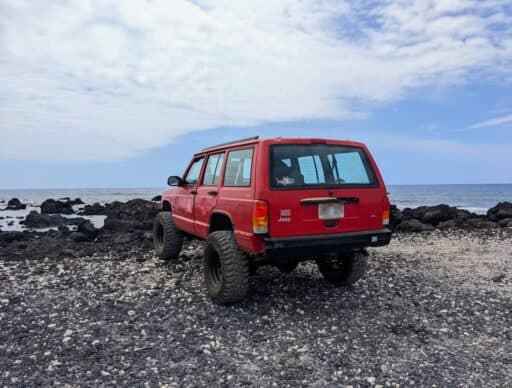 jeep at black and white sand beach