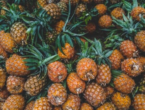 pile of pineapples with green leaves