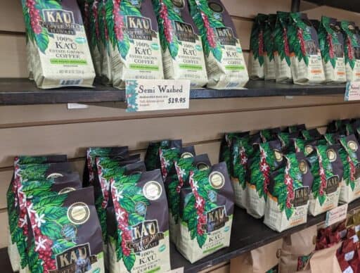 display shelves in a kau coffee mill gift shop with bags of coffee for sale; great hawaiian souvenirs to bring home
