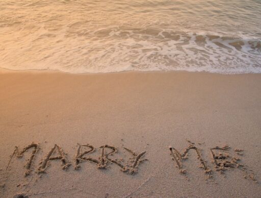 "marry me" written in sand on beach, a Big Island proposal idea
