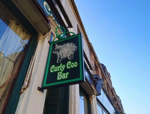 curly coo bar sign at the front of the building