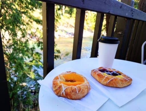 pastries and coffee on porch table with wenatchee river in background