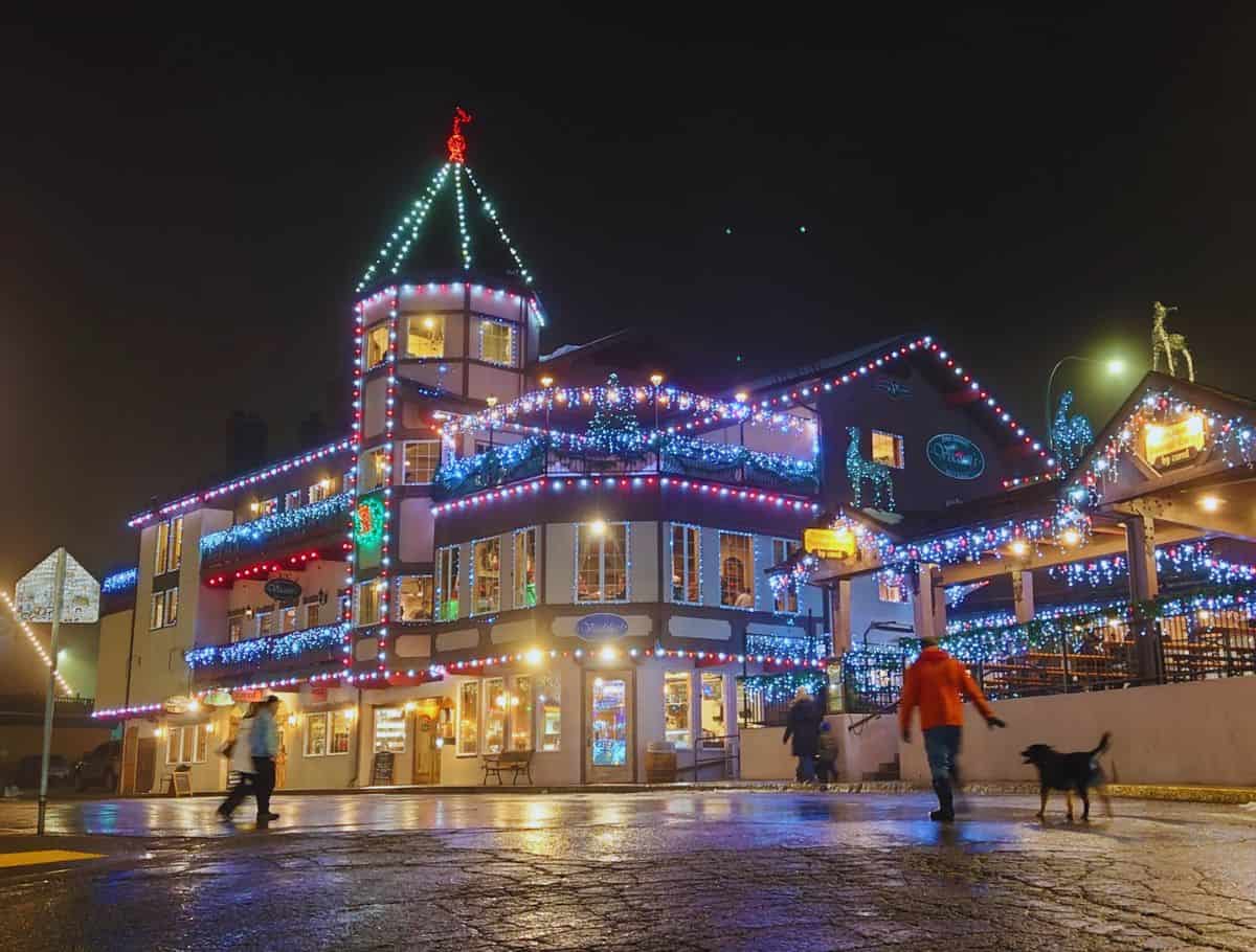 leavenworth building lit up with christmas lights with people walking by