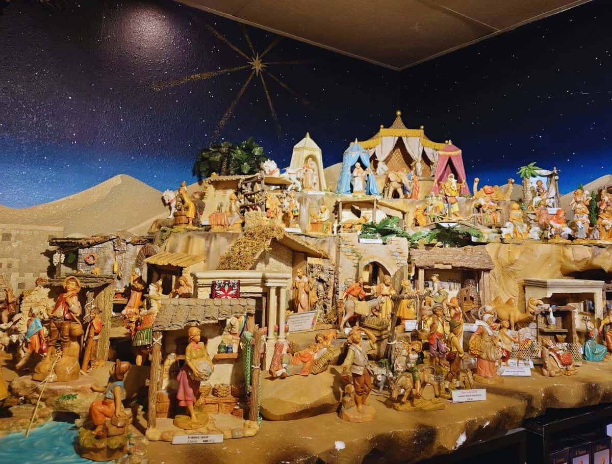 Fontanini nativity village at Kris Kringle with many figurines and buildings on display