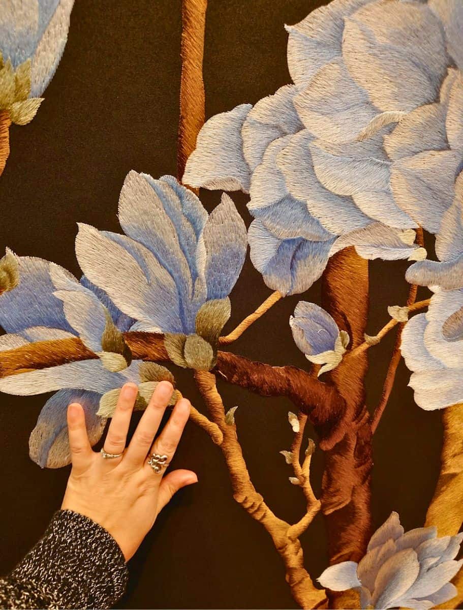 my hand for scale and close up of embroidered wallpaper