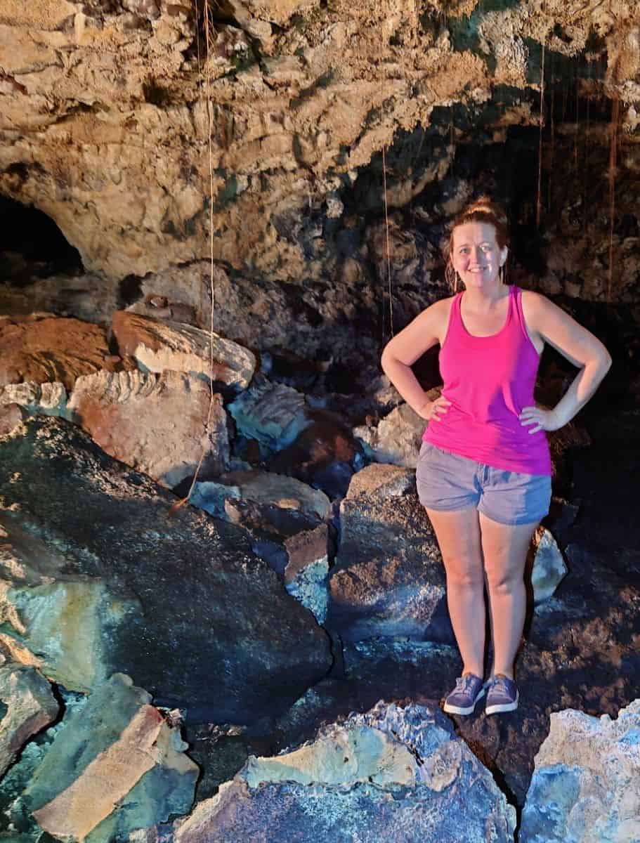 me standing in a kula kai cave with light illuminating the rocky interior, a natural exploration activity on the Big Island when it rains.