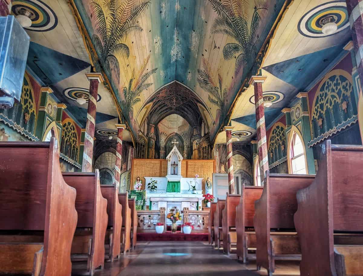 The ornately decorated interior of Painted Church in Captain Cook, Big Island, reflecting the cultural and historical sites to visit