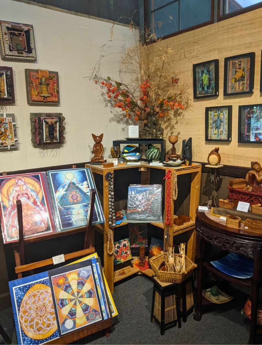 Eclectic art gallery interior with a variety of vibrant artwork, sculptures, and cultural pieces, displaying the rich artistic offerings available for visitors at volcano garden arts