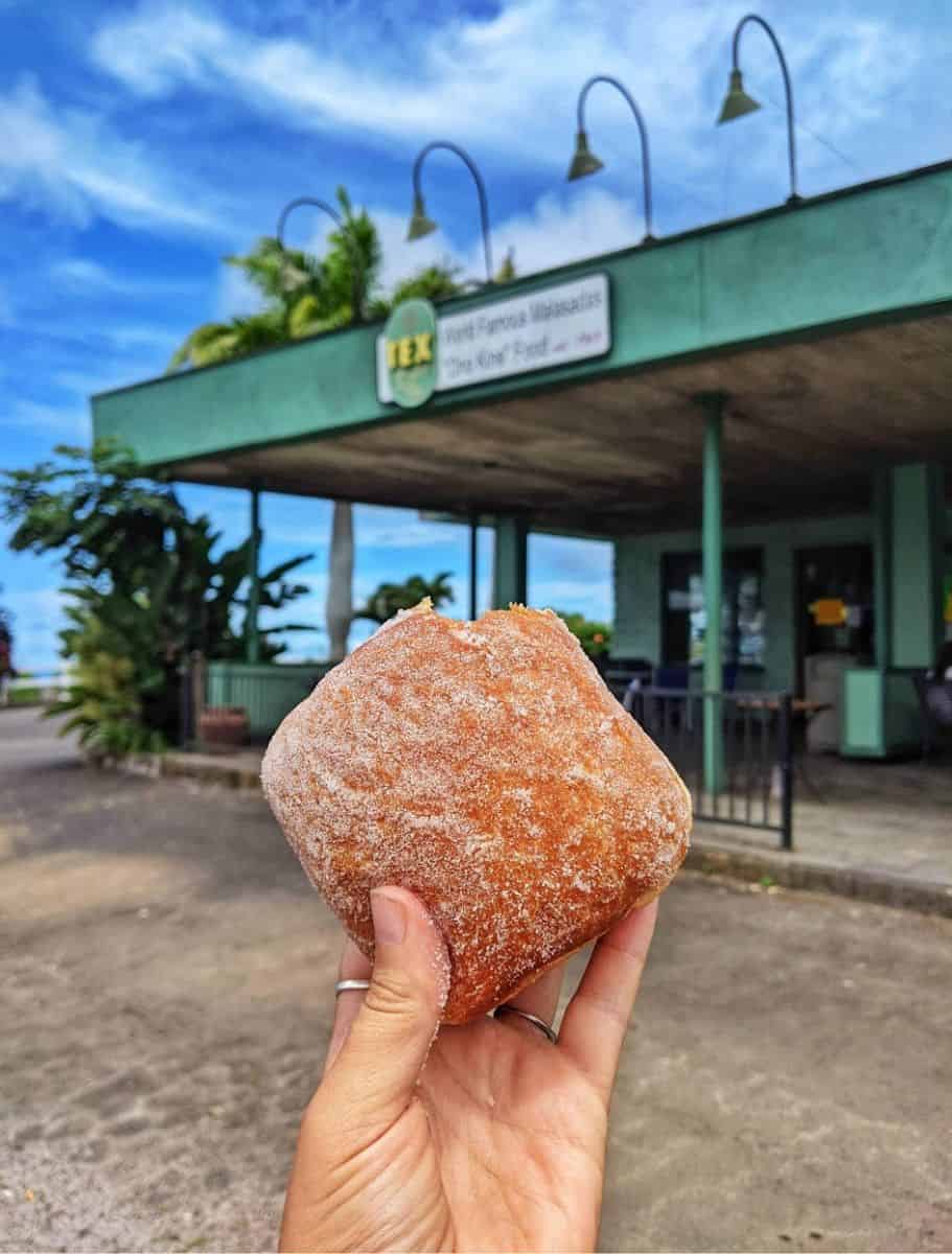my hand holding a large malasada from tex drive in