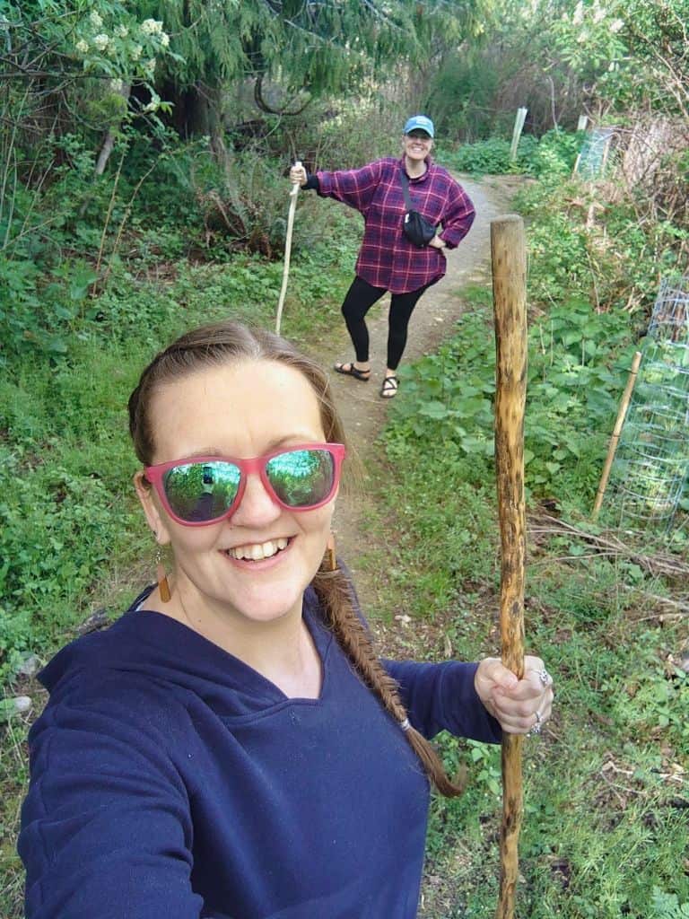 selfie of Me and friend using the walking sticks on Dog Woods trail for fun!