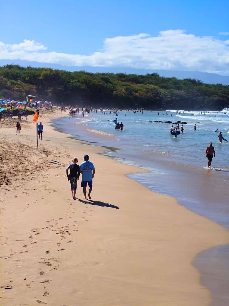 people walking and playing on hapuna beach