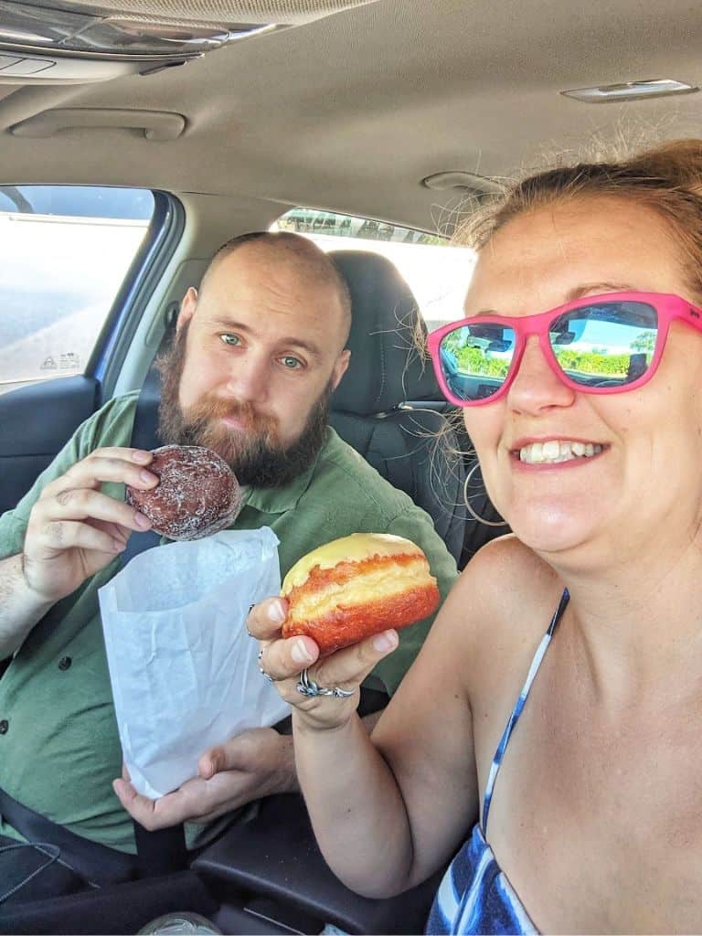 Michael and I enjoying Punalu'u Bake Shop malasadas in the car