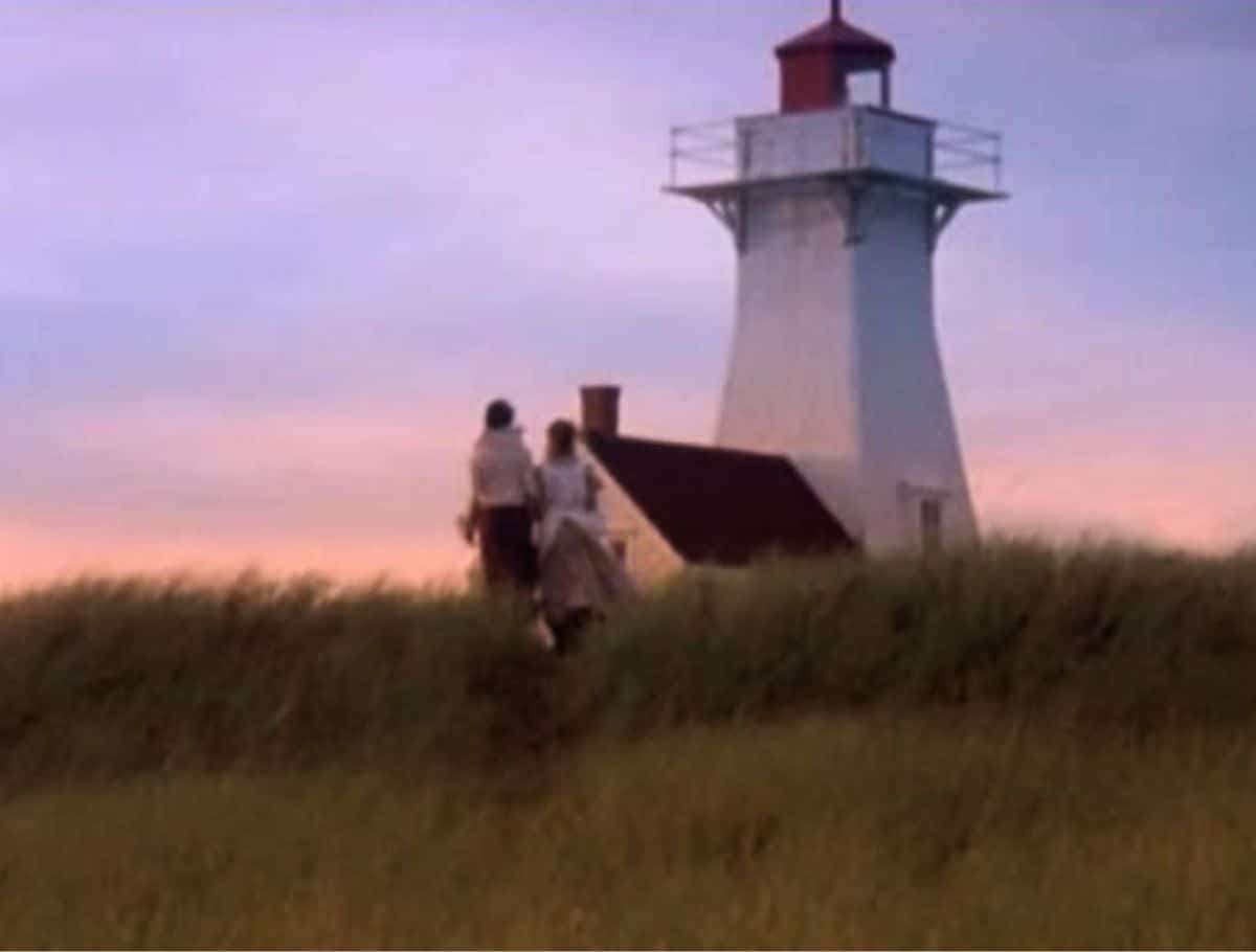 Scene of Anne & Diana with backs to camera at Avonlea lighthouse during sunset