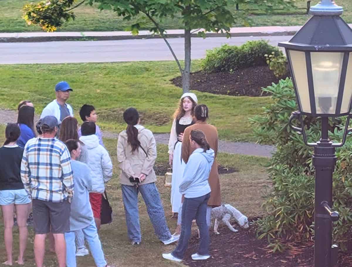 Charlottetown ghost walking tour with guide dressed in period attire surrounded by tourists