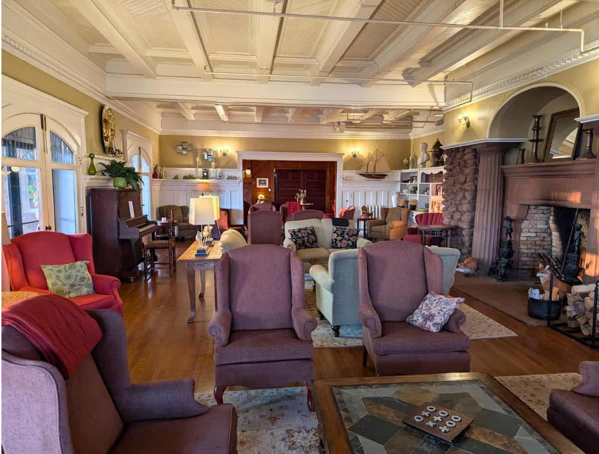 view of entire library with sea of couches and chairs. you can see the piano and fireplace as well