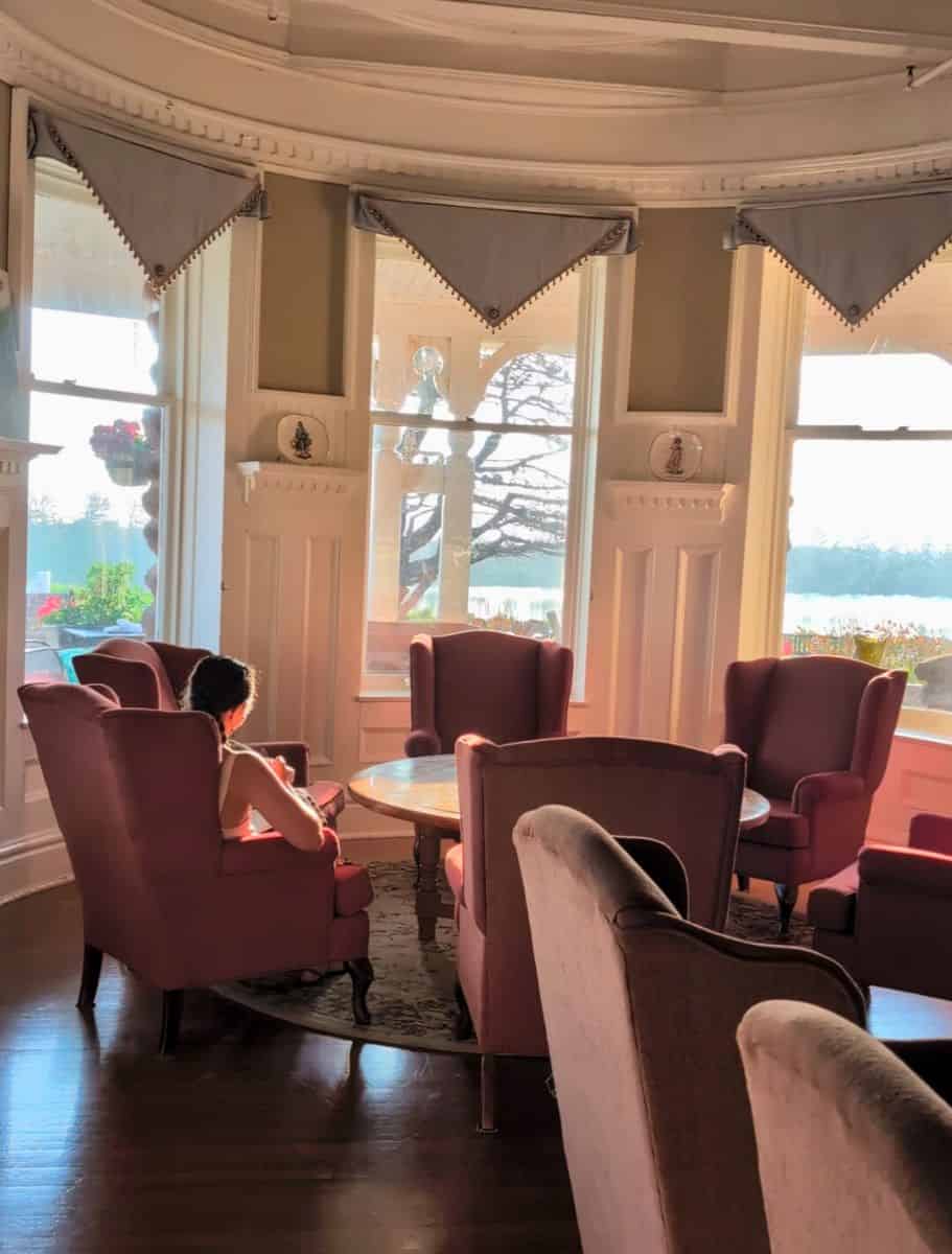 circular nook of wing back chairs in a circle around a coffee table by the window in the library