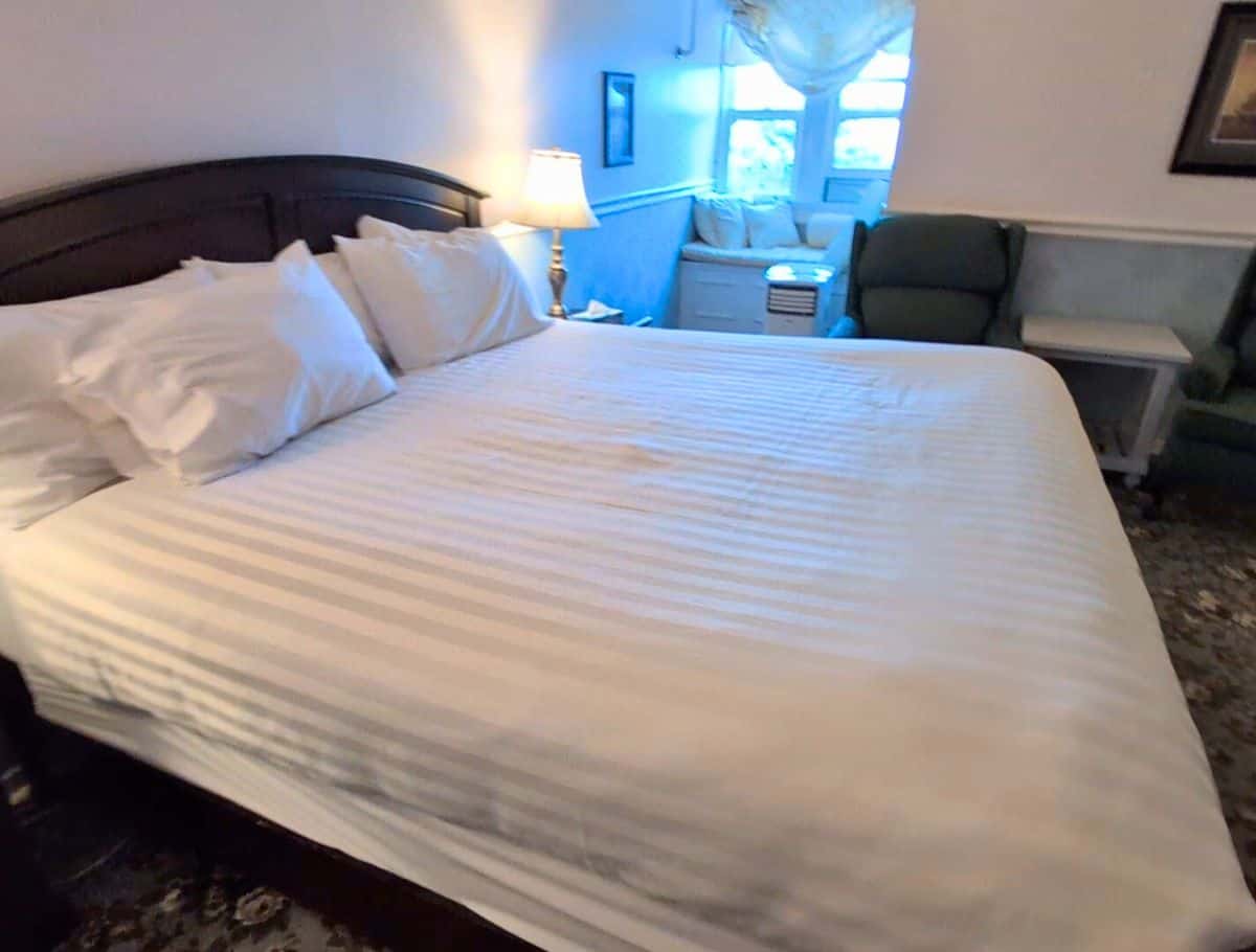Our King Bed with a Water View room with window seat in background