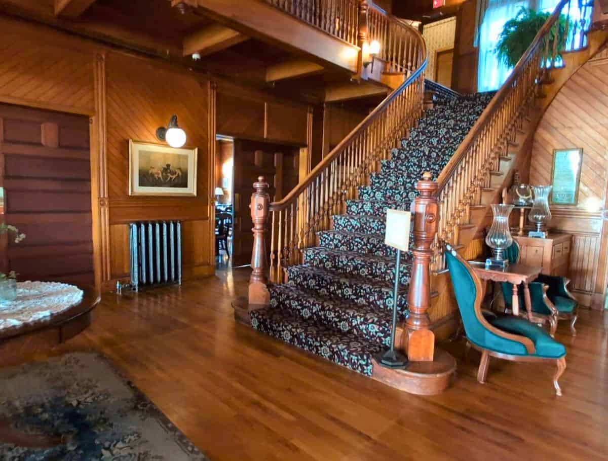 Grand staircase in the lobby carpeted with a floral design