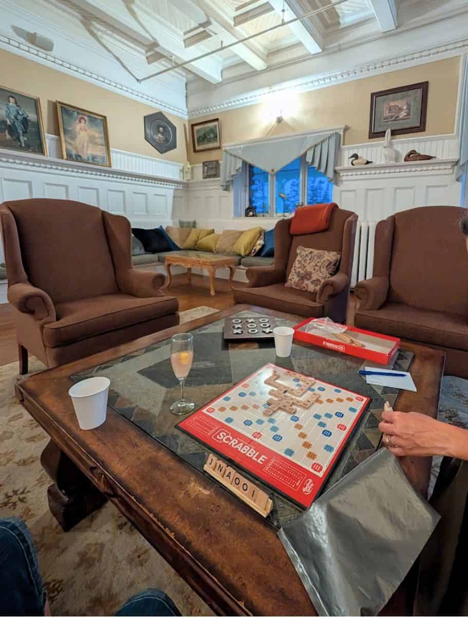 scrabble board on coffee table in library with wingback chairs