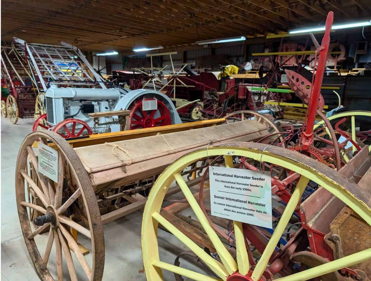 Shop full of old, rusty farm equipment at Canadian Potato Museum like the international harvester seeder