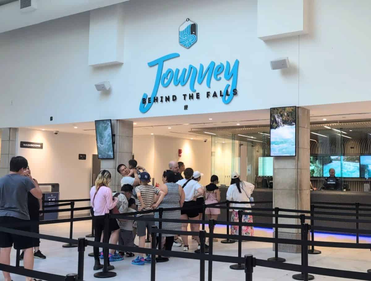 Ticket booth and entrance to Journey Behind the Falls with people standing in line