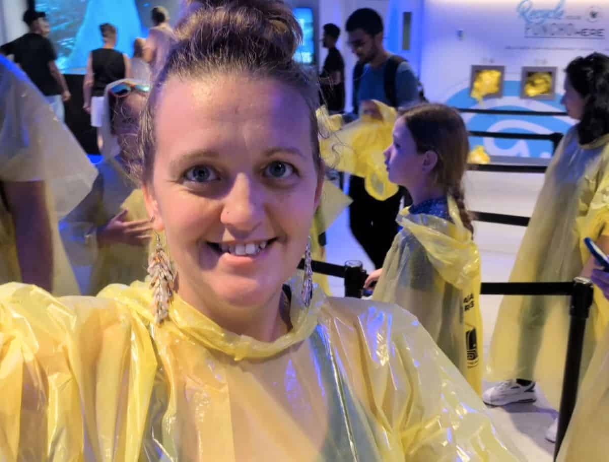 Me in a poncho waiting in line for the elevator