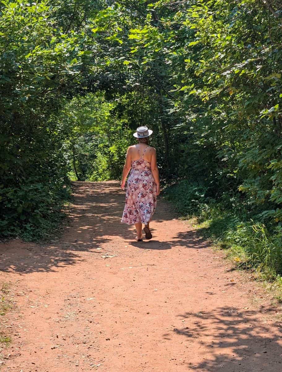 Me with to camera walking Lover's Lane, a gravel trail with tree tunnel