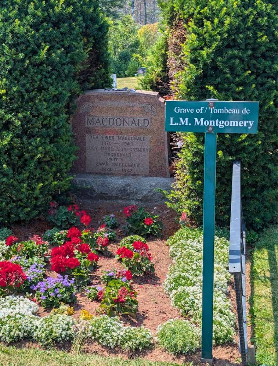 L.M. Montgomery grave with a plot of planted flowers.
headstone reads: Macdonald; Rev Ewen MacDonald 1870-1943; Lusy Maud Montgomery MacDonald wife of Ewan MacDonald 1874-1942