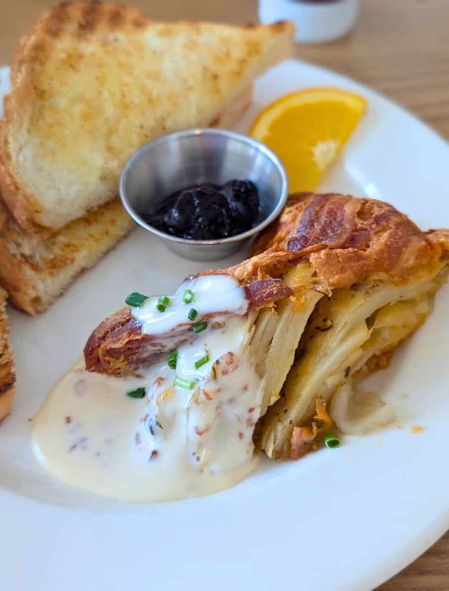 Potato Pie from PEI Preserve Co with layers of potatoes, bacon crust, and cream sauce