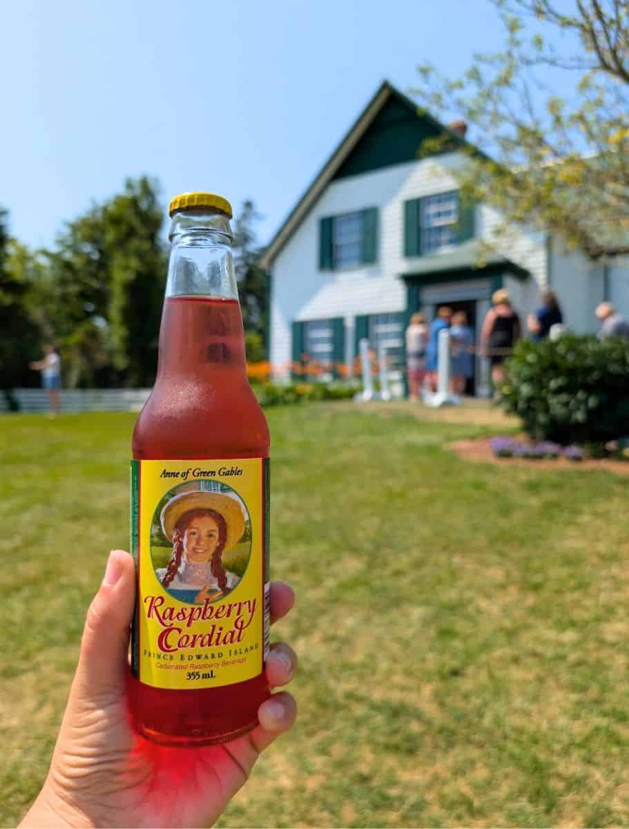 bottle of anne's raspberry cordial in front of green gables heritage palce