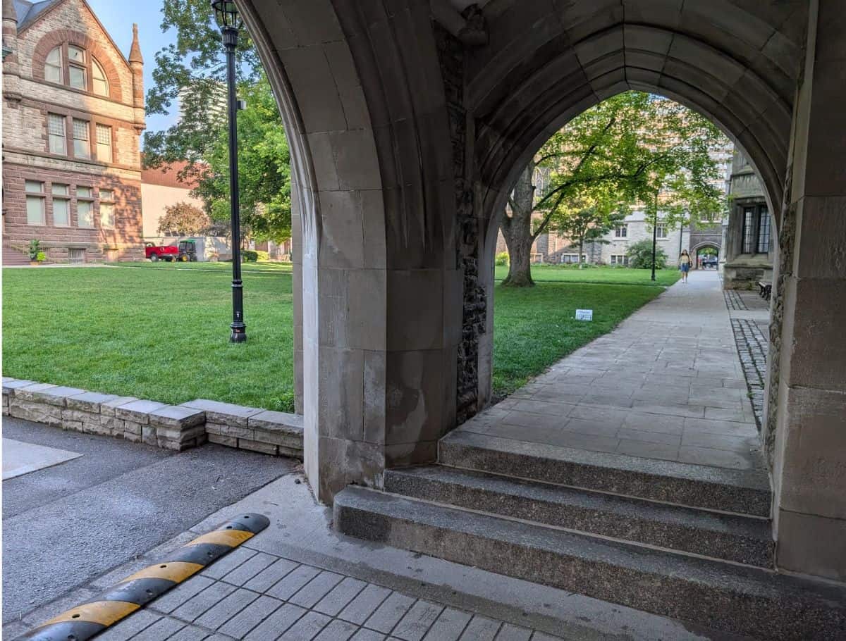 stone archway with steps with grass lawn in background
