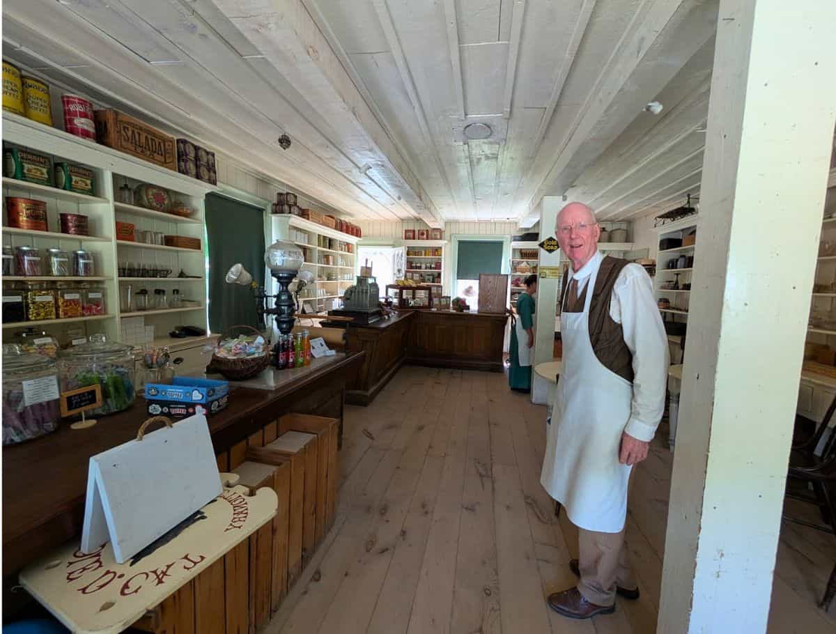 David dressed in white apron in the General Store at Westfield Heritage Museum